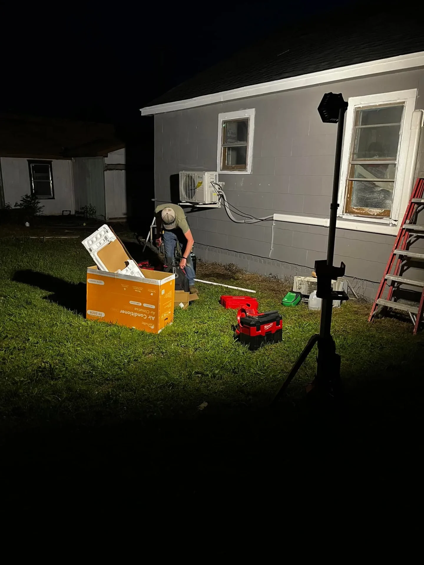 Technician installing mini-split at night in Perkins Oklahoma