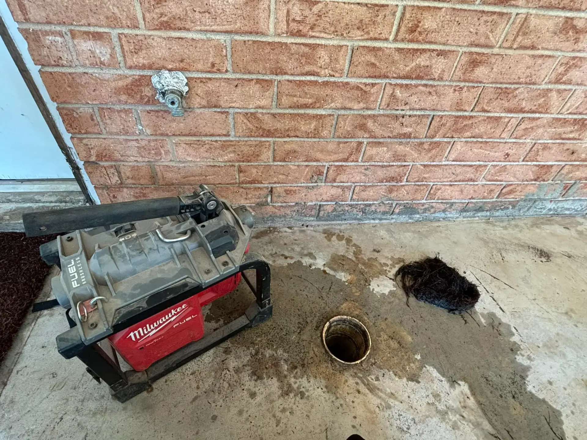 Clogged PVC pipe with root removal during drain cleaning