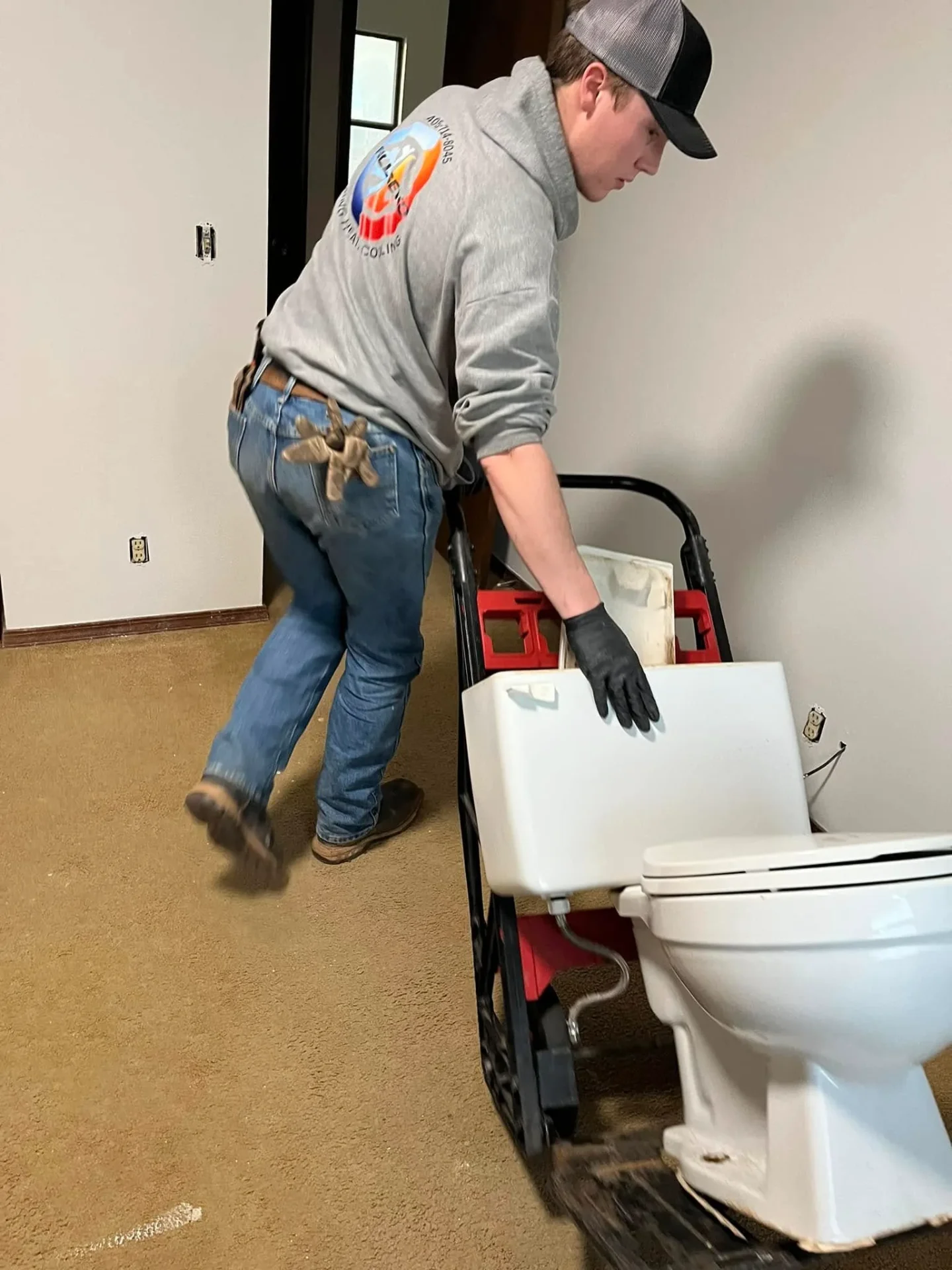 Technician moving new toilet for installation in Perkins Oklahoma