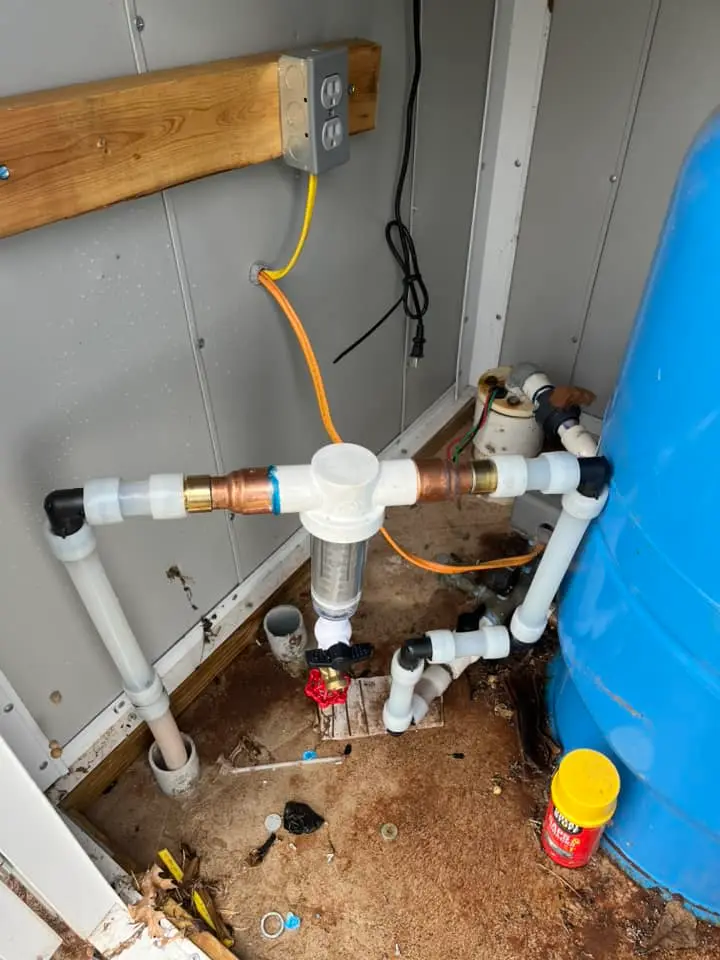 Water filtration system with filter pipes and blue tank in Perkins Oklahoma