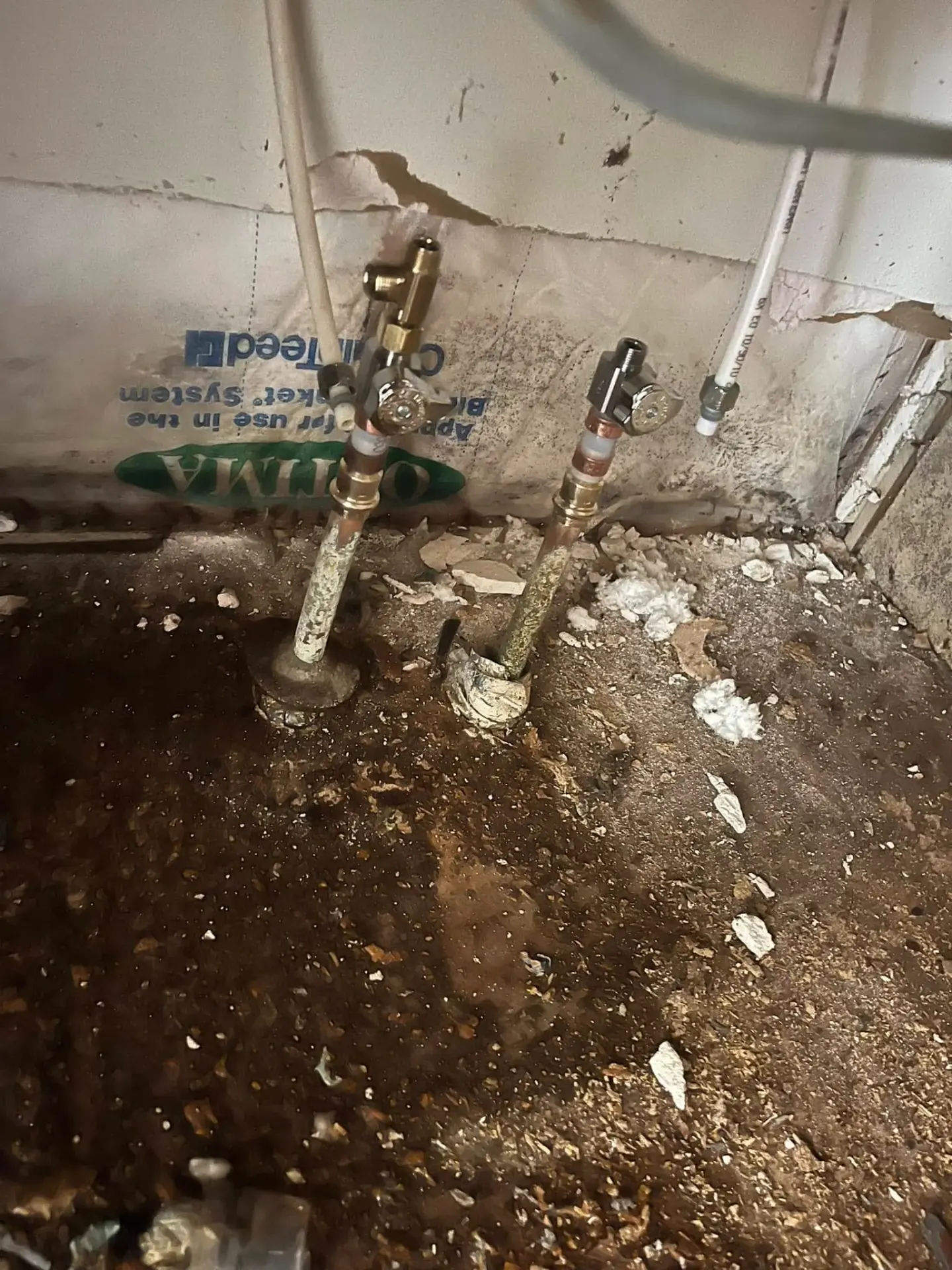 Old water lines under house inspected during water heater repair